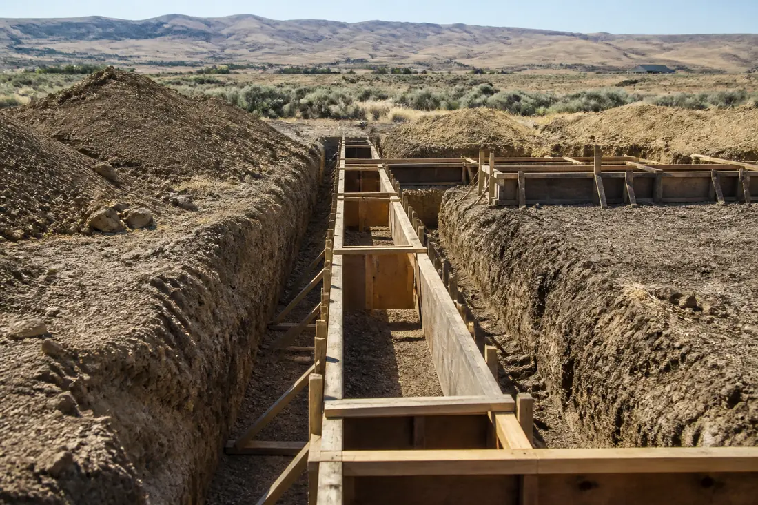 An excavated footing trench with formwork ready for concrete on an Idaho site